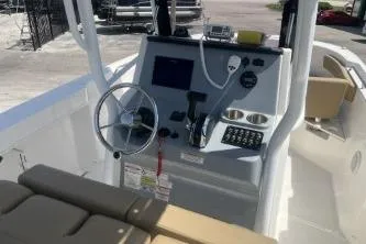 Slide: The Image of 2023 Trophy T24 CC boat console with steering wheel and navigation controls. - 9