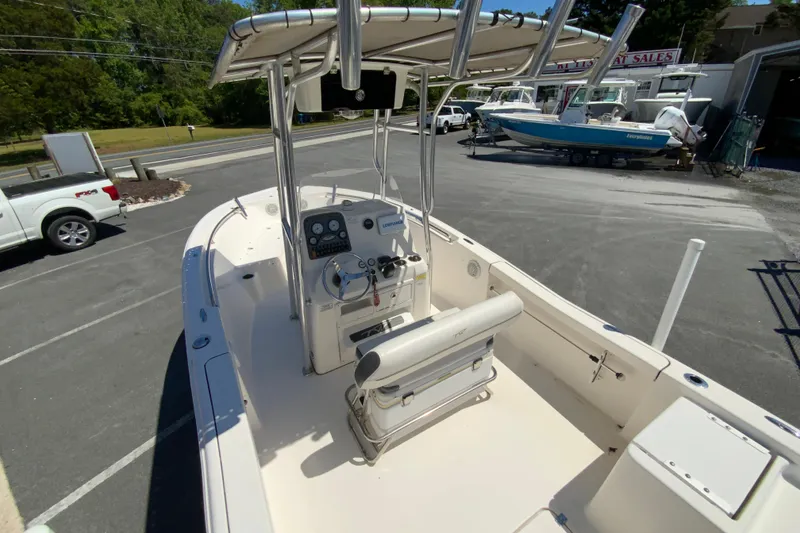 Slide: The Image of 2015 Tidewater 198 CC Adventure boat with center console and T-top in a parking lot. - 10