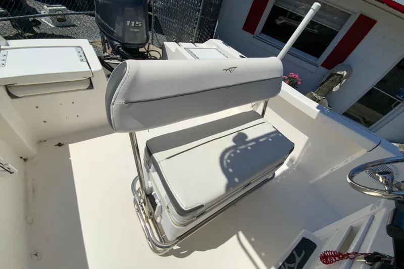 Slide: The Image of 2015 Tidewater 198 CC Adventure boat interior with seating and Yamaha 115 engine. - 13