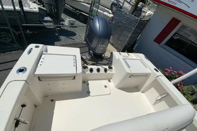 Slide: The Image of 2015 Tidewater 198 CC Adventure boat with Yamaha 115 engine, docked near a service area. - 14