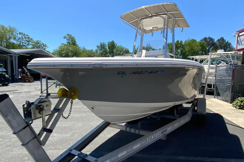 Slide: The Image of 2015 Tidewater 198 CC Adventure boat on trailer, parked outdoors under clear blue sky. - 5