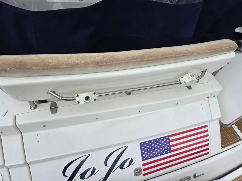 Slide: The Image of The image shows the stern of a 2005 Regal 3360 Window Express boat with an American flag. - 32