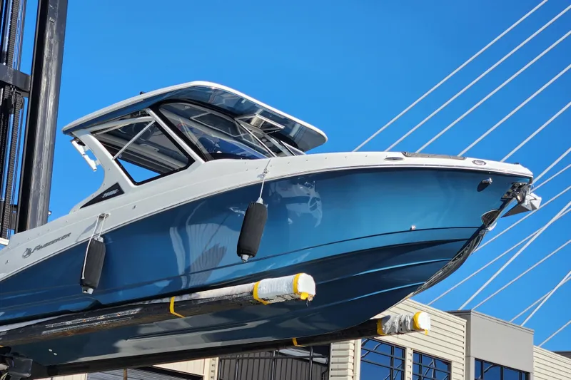Slide: The Image of 2022 Finseeker 280 DC boat lifted against blue sky background. - 1