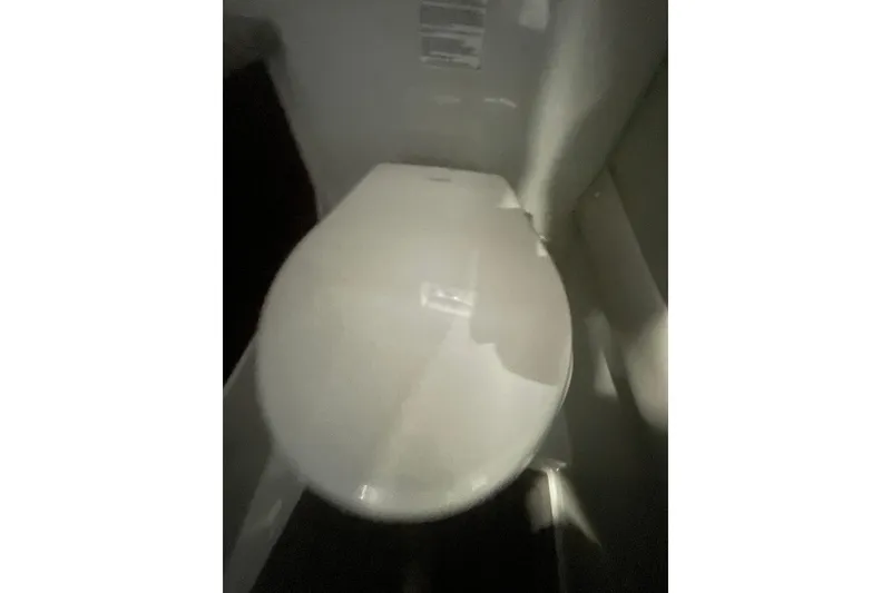 Slide: The Image of Toilet inside 2022 Finseeker 280 DC boat, showcasing compact marine bathroom design. - 19