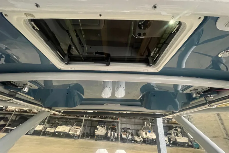 Slide: The Image of 2022 Finseeker 280 DC boat interior view with open hatch and storage area. - 20