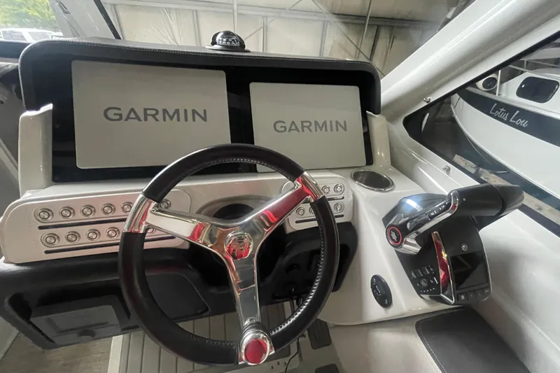 Slide: The Image of Cockpit of 2022 Finseeker 280 DC with Garmin displays and steering wheel. - 21