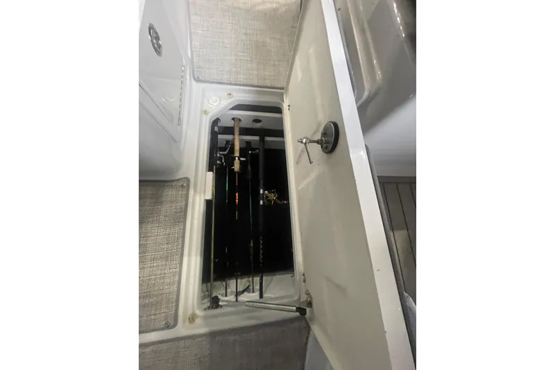 Slide: The Image of 2022 Finseeker 280 DC boat rod storage compartment with fishing rods. - 23