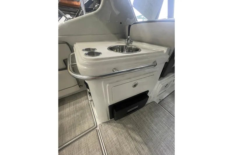 Slide: The Image of Interior view of 2022 Finseeker 280 DC boat featuring a compact sink and storage area. - 24