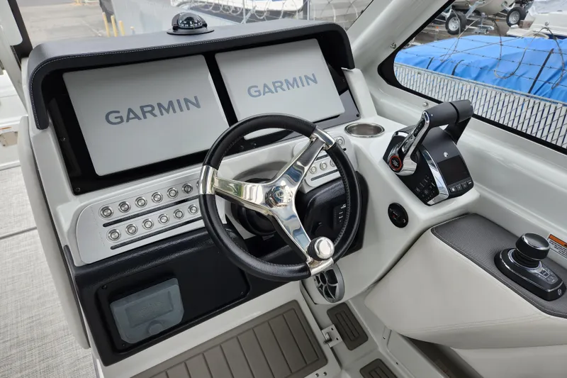 Slide: The Image of Cockpit of 2022 Finseeker 280 DC with Garmin displays and steering wheel. - 4