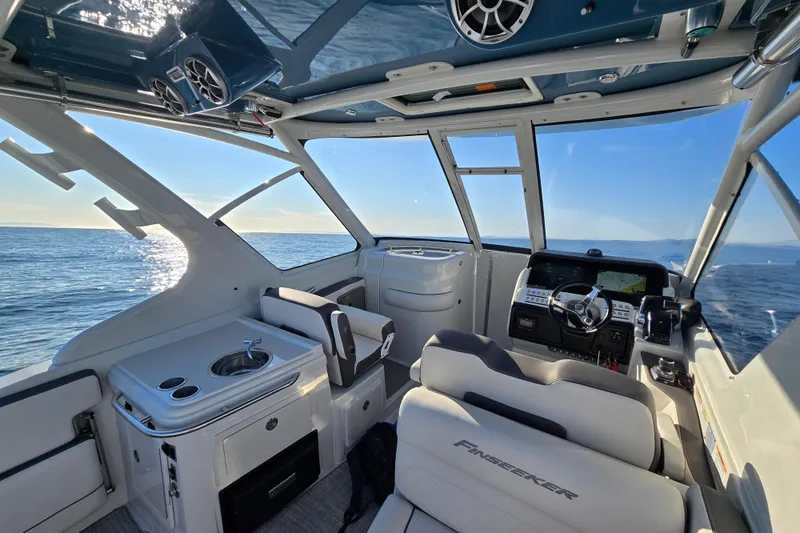 Slide: The Image of Interior of 2022 Finseeker 280 DC boat with ocean view and modern controls. - 5