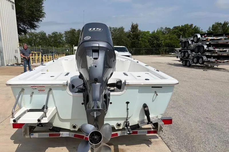 Slide: The Image of 2013 Sportsman Masters 207 Bay Boat on trailer, featuring powerful outboard motor. - 13