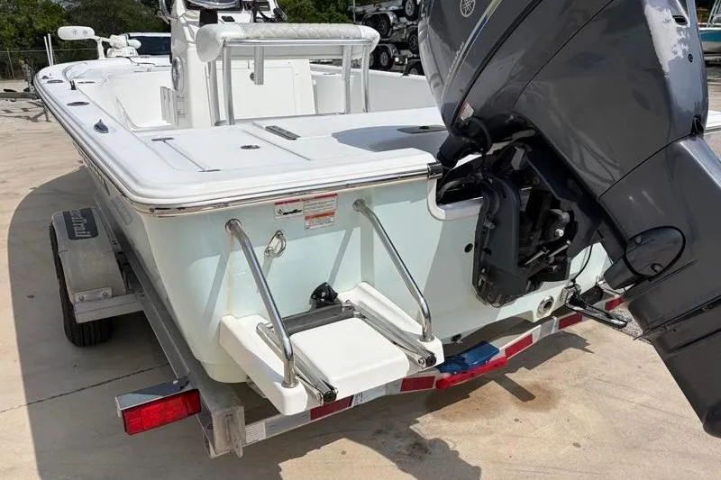 Slide: The Image of 2013 Sportsman Masters 207 Bay Boat with outboard motor on trailer. - 14