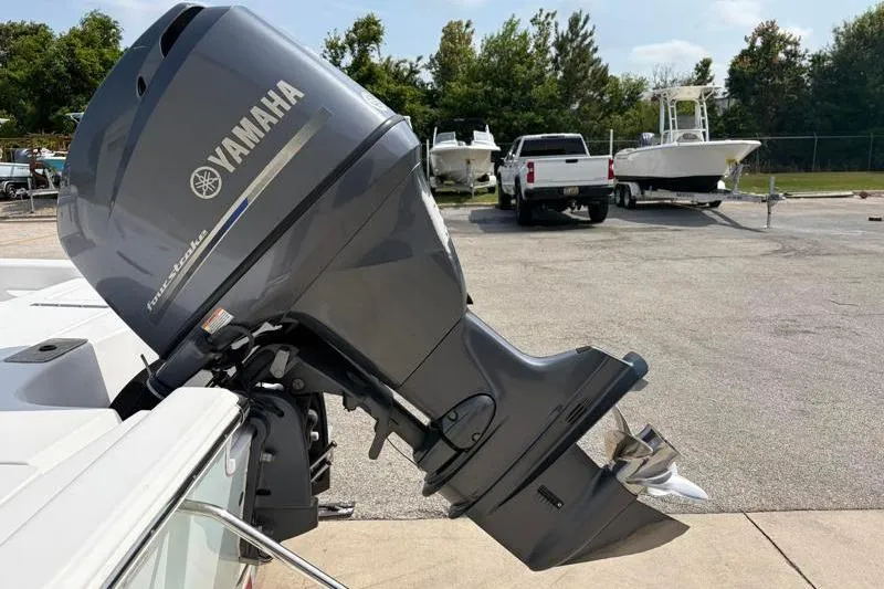 Slide: The Image of 2013 Sportsman Masters 207 Bay Boat with Yamaha outboard motor in a parking lot. - 16