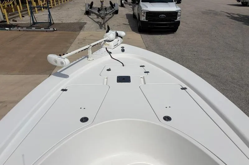 Slide: The Image of 2013 Sportsman Masters 207 Bay Boat with trolling motor, parked near a truck. - 18