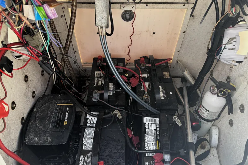 Slide: The Image of Battery compartment of a 2013 Sportsman Masters 207 Bay Boat with wiring and fire extinguisher. - 23