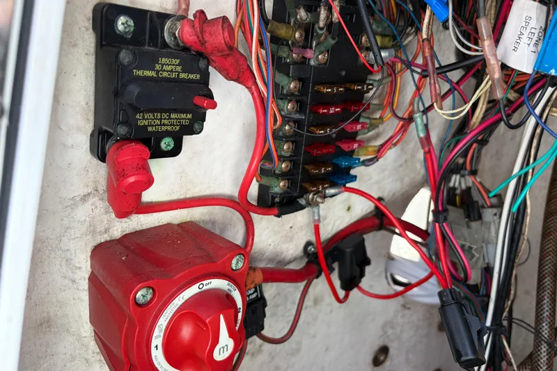 Slide: The Image of Electrical wiring and circuit breakers inside a 2013 Sportsman Masters 207 Bay Boat. - 24