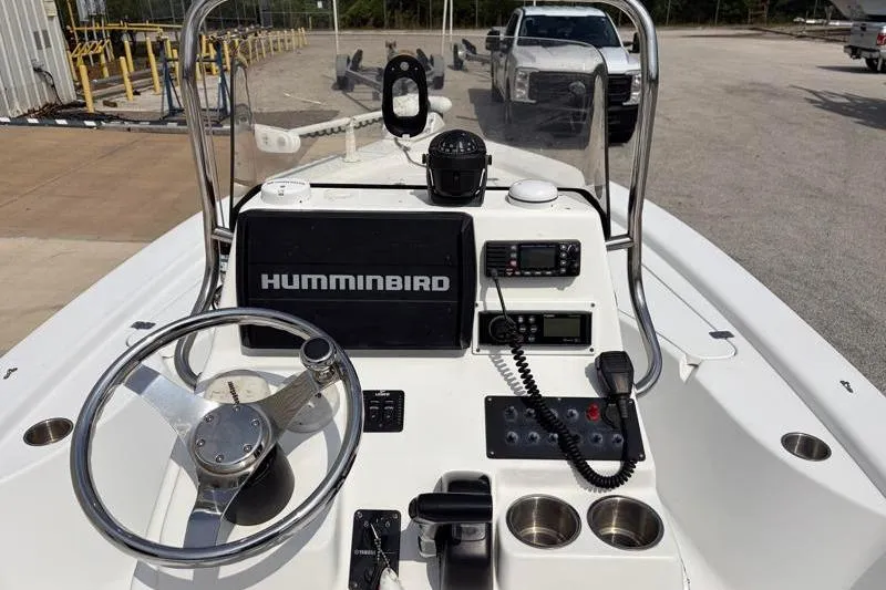 Slide: The Image of 2013 Sportsman Masters 207 Bay Boat dashboard with Humminbird electronics and steering wheel. - 30