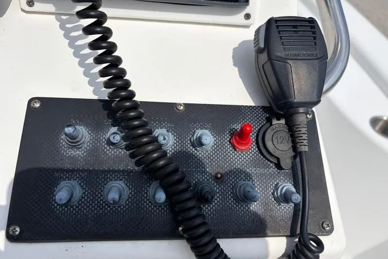 Slide: The Image of Control panel of a 2013 Sportsman Masters 207 Bay Boat with switches and microphone. - 33