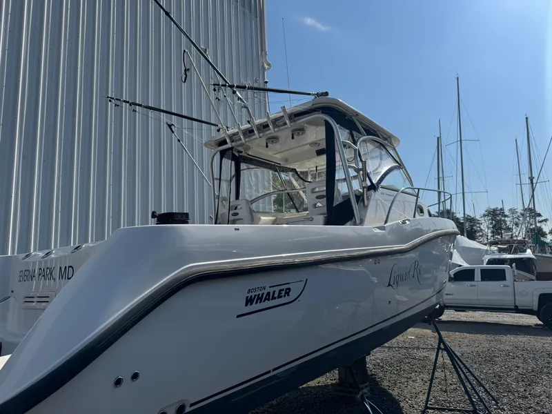 Slide: The Image of 2006 Boston Whaler 305 Conquest boat docked, side view. - 11