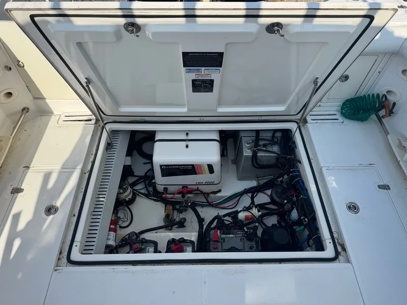 Slide: The Image of Engine compartment of a 2006 Boston Whaler 305 Conquest boat. - 16