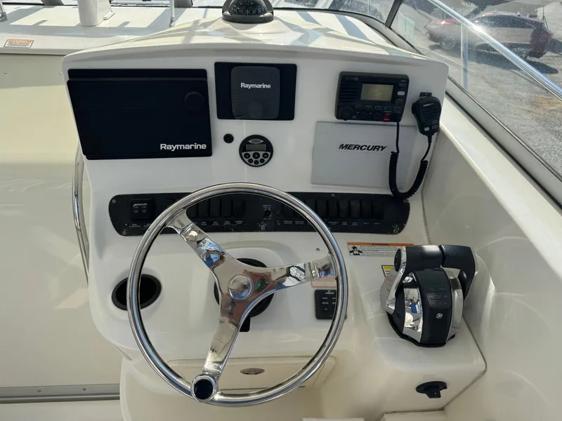 Slide: The Image of 2006 Boston Whaler 305 Conquest helm with Raymarine equipment. - 21