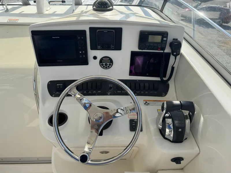 Slide: The Image of 2006 Boston Whaler 305 Conquest helm with navigation system. - 22