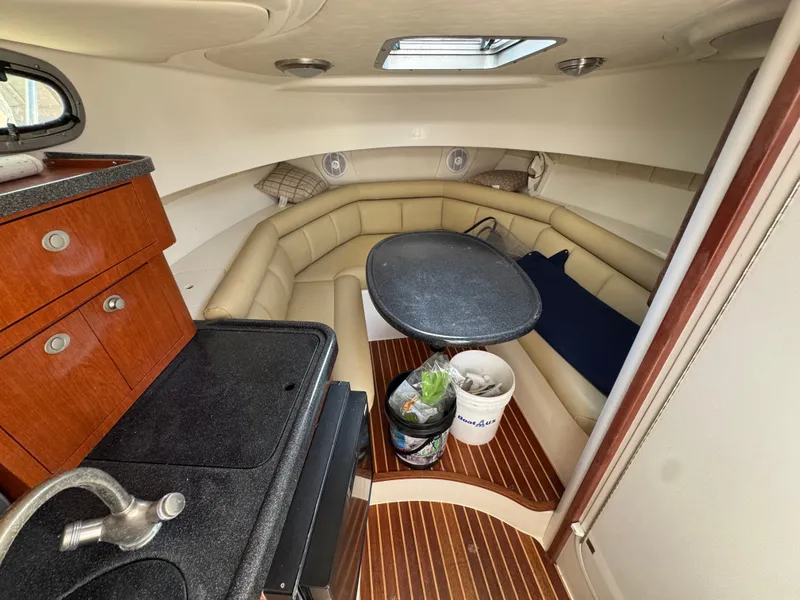 Slide: The Image of Interior of 2006 Boston Whaler 305 Conquest with kitchenette and seating area. - 26