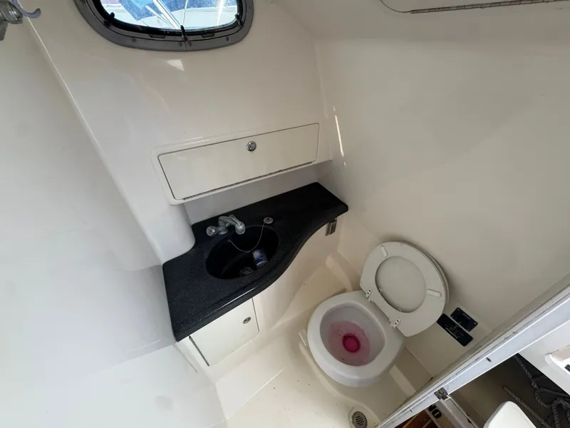 Slide: The Image of Interior of 2006 Boston Whaler 305 Conquest with toilet and sink. - 28