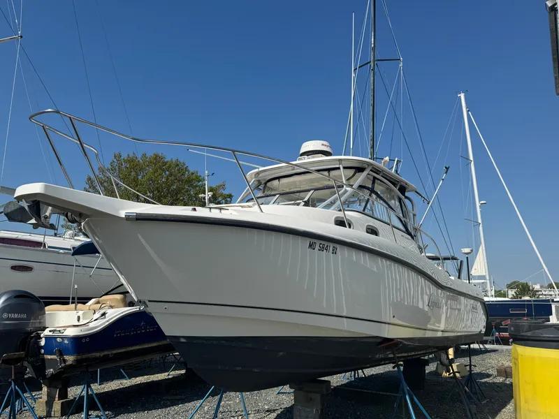 Slide: The Image of 2006 Boston Whaler 305 Conquest boat on a dry dock. - 3