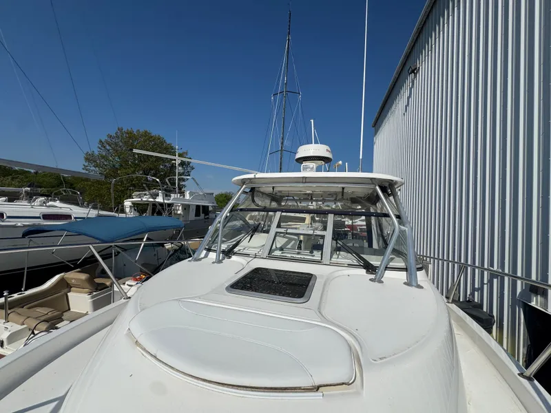 Slide: The Image of 2006 Boston Whaler 305 Conquest boat docked, blue sky. - 30