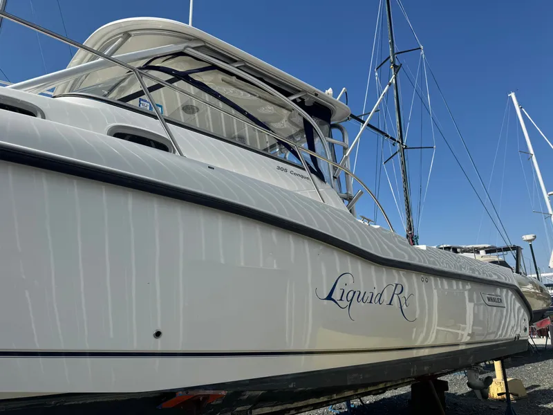 Slide: The Image of 2006 Boston Whaler 305 Conquest boat in dry dock. - 6