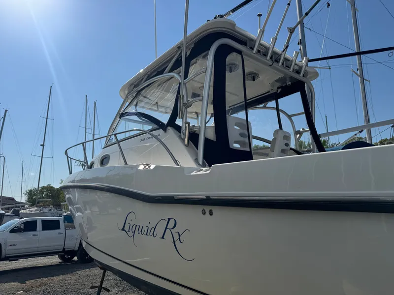 Slide: The Image of 2006 Boston Whaler 305 Conquest boat docked, side view. - 7