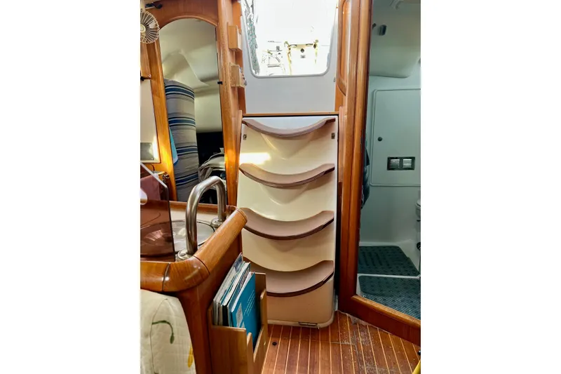 Slide: The Image of Interior of 2004 Jeanneau Sun Odyssey 40 sailboat, featuring wooden cabinetry and compact design. - 1