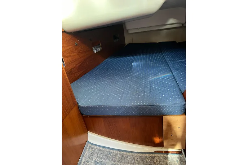 Slide: The Image of Interior cabin of 2004 Jeanneau Sun Odyssey 40 with blue cushioned seating. - 11