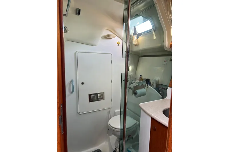 Slide: The Image of Bathroom interior of 2004 Jeanneau Sun Odyssey 40 yacht, featuring compact design and amenities. - 12