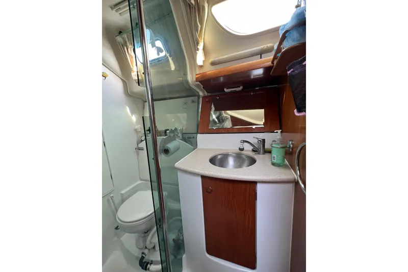 Slide: The Image of Bathroom interior of 2004 Jeanneau Sun Odyssey 40 sailboat, featuring sink and toilet. - 13