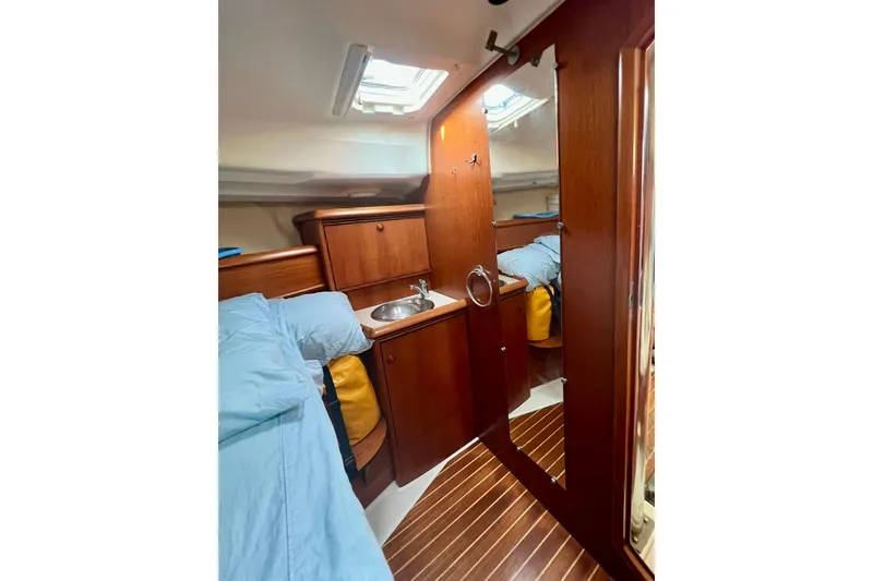 Slide: The Image of Interior of 2004 Jeanneau Sun Odyssey 40 yacht with wood finish and compact sink. - 8