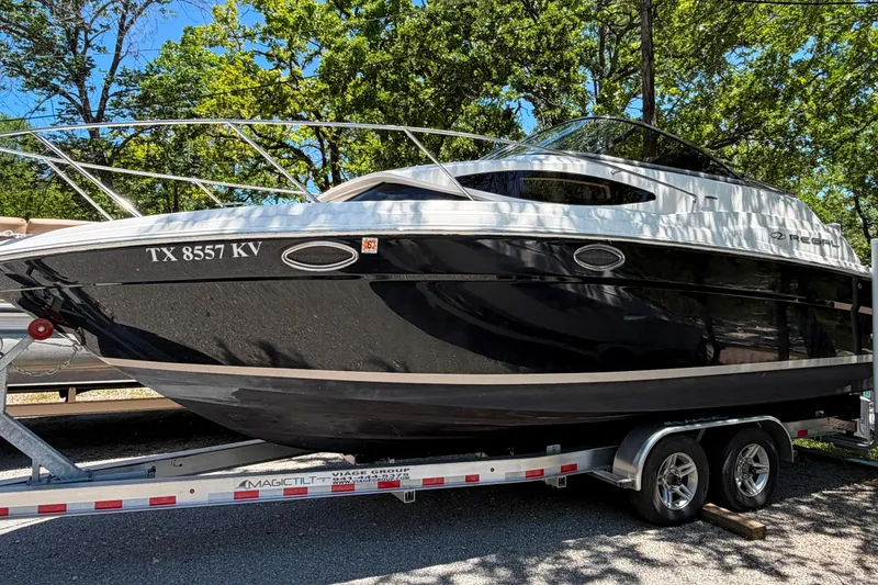 The Image of 2008 Regal 2565 Window Express boat on trailer, parked outdoors with trees in background. - 0
