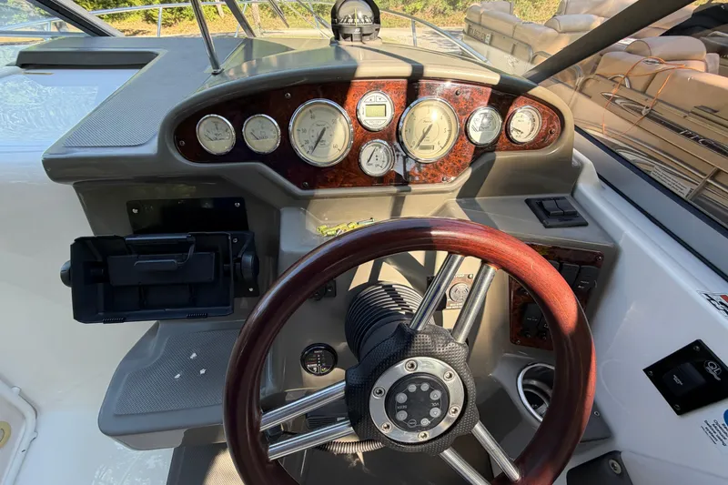 Slide: The Image of 2008 Regal 2565 Window Express dashboard with wood-trimmed steering wheel and instrument panel. - 10
