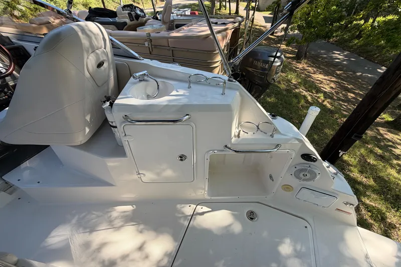 Slide: The Image of 2008 Regal 2565 Window Express boat interior with sink and seating area. - 13