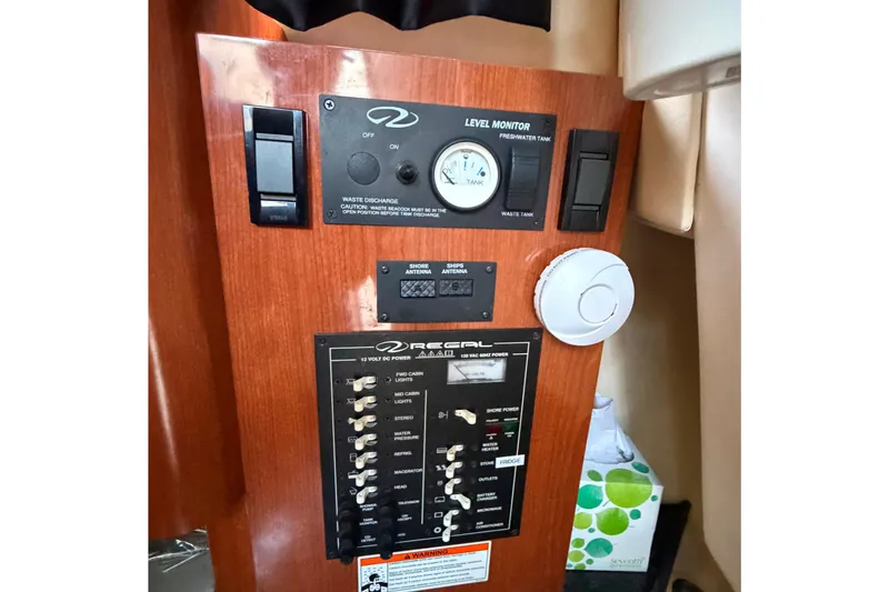 Slide: The Image of 2008 Regal 2565 Window Express control panel with level monitor and switches. - 16