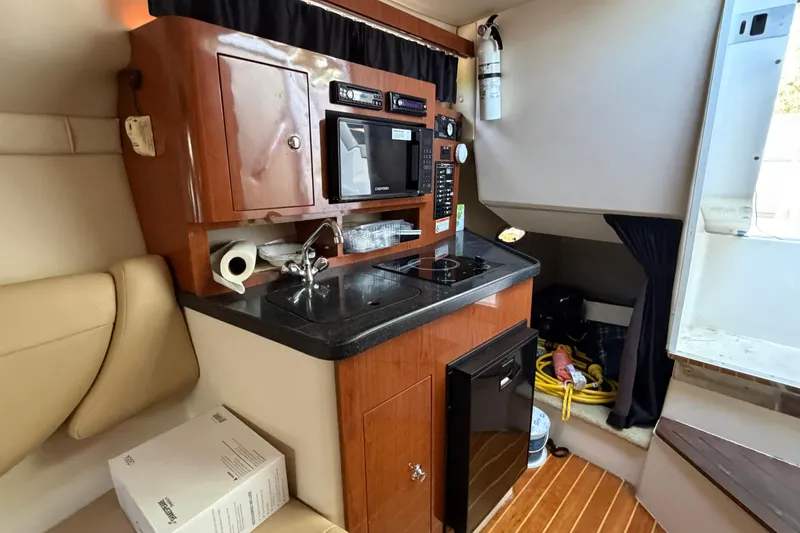 Slide: The Image of 2008 Regal 2565 Window Express boat interior with kitchenette, sink, and appliances. - 20