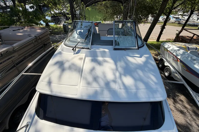 Slide: The Image of 2008 Regal 2565 Window Express boat docked among trees and other boats. - 4