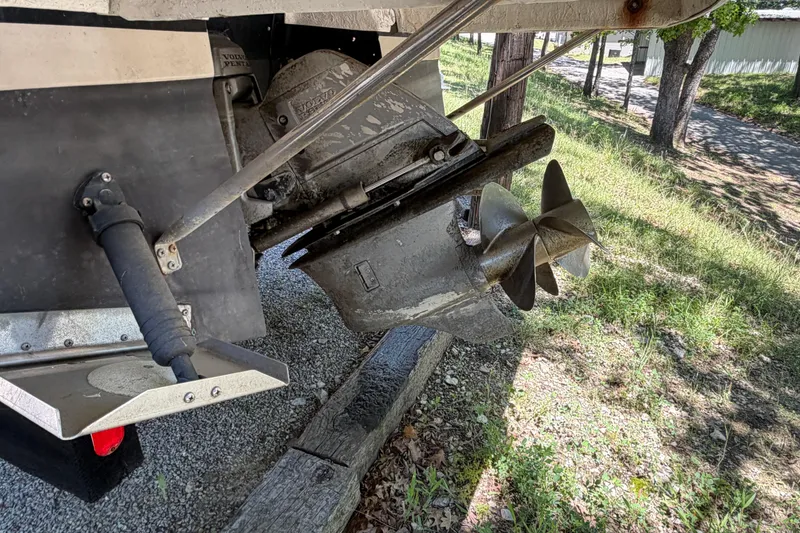 Slide: The Image of 2008 Regal 2565 Window Express boat propeller and drive system, parked on gravel. - 5