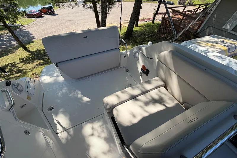 Slide: The Image of 2008 Regal 2565 Window Express boat interior with cushioned seating and lake view. - 6