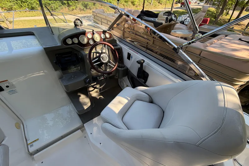 Slide: The Image of 2008 Regal 2565 Window Express boat cockpit with steering wheel and comfortable seating. - 7