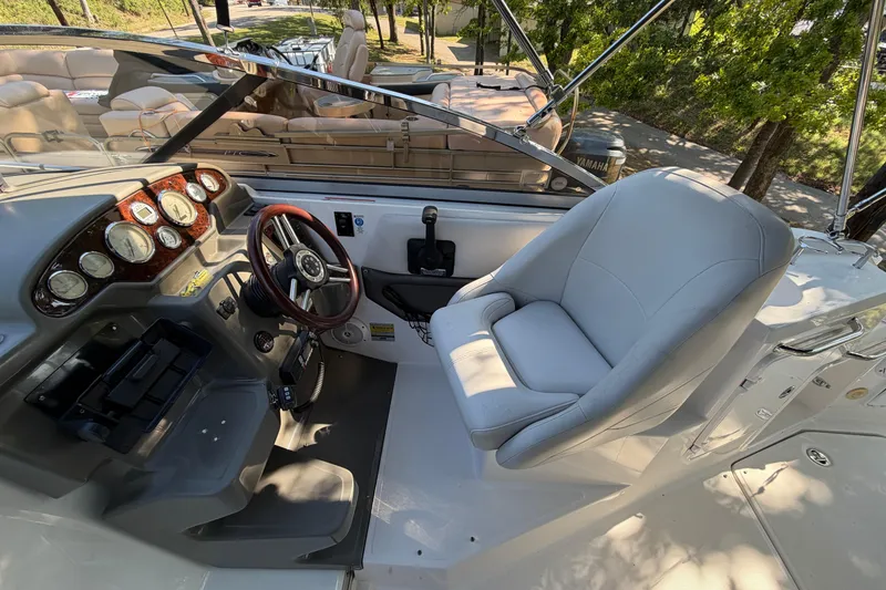 Slide: The Image of 2008 Regal 2565 Window Express boat cockpit with steering wheel and comfortable seating. - 8