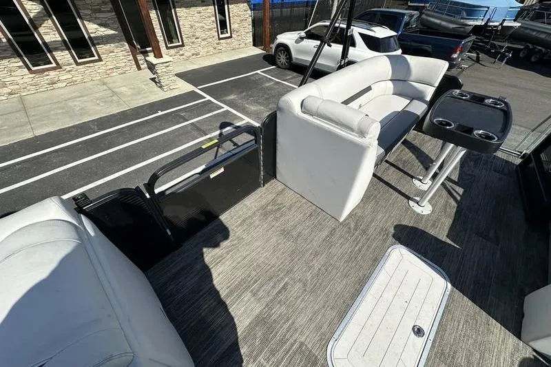 Slide: The Image of 2022 Godfrey Sweetwater 2186 C4 pontoon boat interior with seating and table. - 1