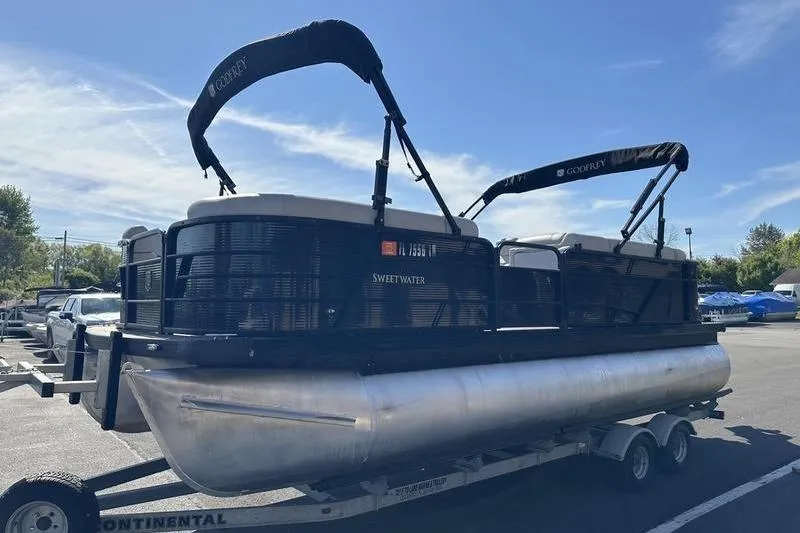 Slide: The Image of 2022 Godfrey Sweetwater 2186 C4 pontoon boat on trailer, parked outdoors. - 13