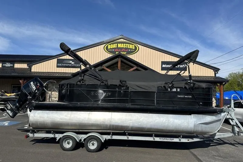 Slide: The Image of 2022 Godfrey Sweetwater 2186 C4 pontoon boat on trailer outside Boat Masters store. - 16